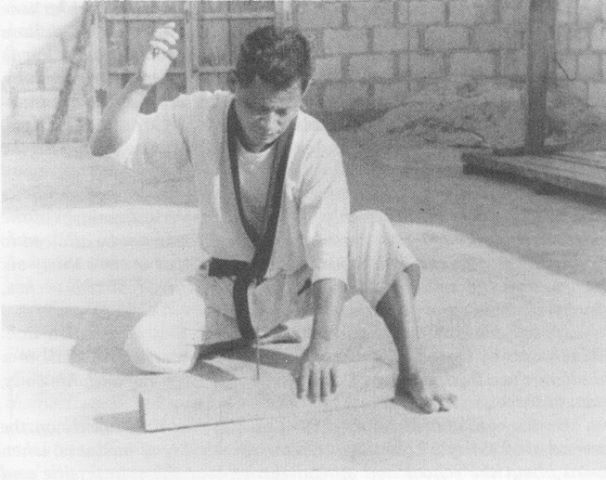 Tatsuo Shimabuku hammering a nail with his hand